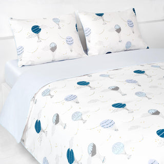 Touch The Sky Full/Queen Duvet Cover in the Blue Print displayed on bed. Shown with two standard size pillow cases in the same print.