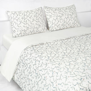 Secret Garden Full/Queen Duvet Cover in the Ivory Print displayed on bed. Shown with two standard size pillow cases in the same print.