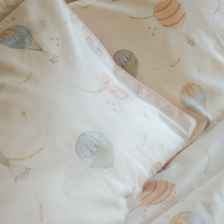 Touch The Sky Full/Queen Duvet Cover in the Pink Print displayed on bed. Shown with two standard size pillow cases in the same print.