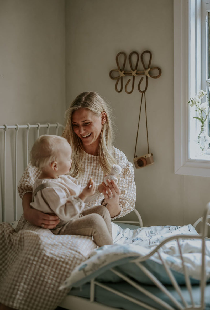 Mother and child sitting on the bed