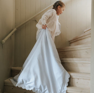 Scalloped Starlight Blue with Girl carrying Toddler Duvet with Pillow upstairs