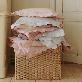 Scalloped Starlight Standard Pillowcase Set and Duvet stacked in a pile in both Blue and Rose.