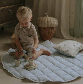 Picnic Gingham Play Mat in Blue with toddler playing on top with toys