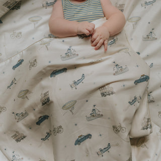 Transport Treasures Toddler Duvet in Blue with child laying down.