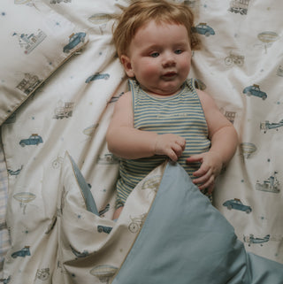Transport Treasures Toddler Duvet in Blue with child laying down.