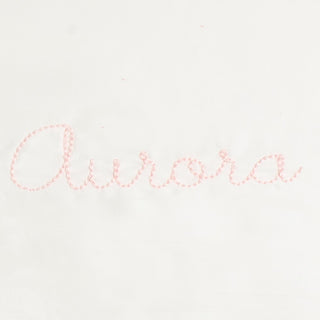 Monogram in pink color thread the name "Aurora"