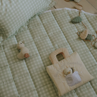 Picnic Gingham Green Playmat with Good night Gooselings book laying on top along with garland and goosie