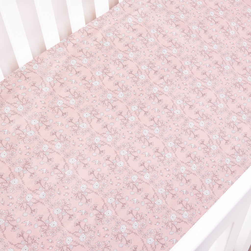 Bird's Song in Pink laid on a Crib Sheet
