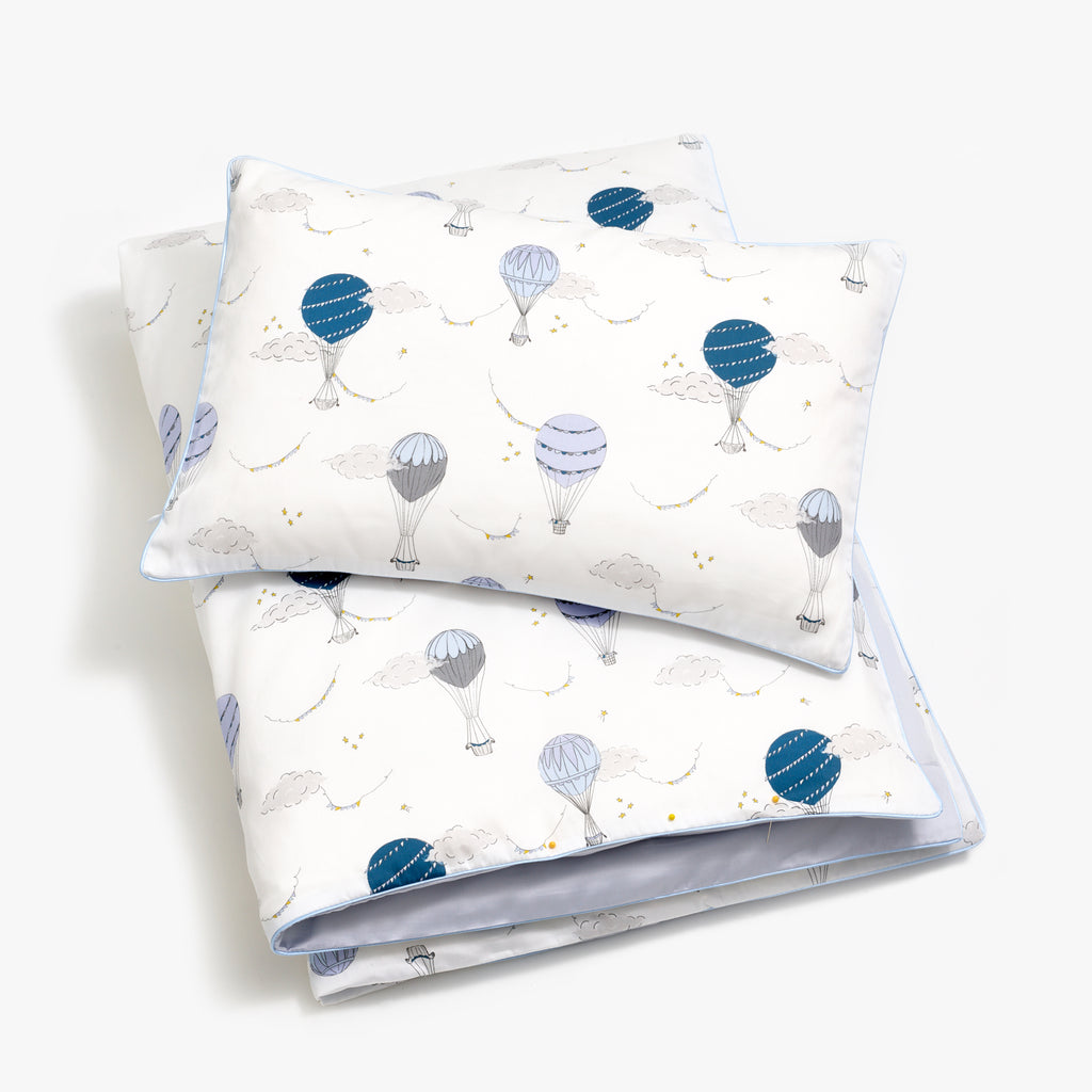 Toddler duvet in the "Touch The Sky" print in the color blue, with the matching toddler pillow