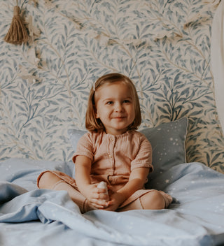 Image of a girl sitting on a bed