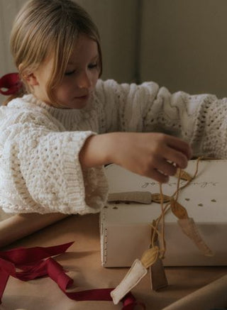 child opening a gooselings gift