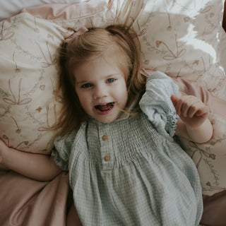 girl on toddler blanket