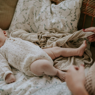 Baby kicking his feet with mom