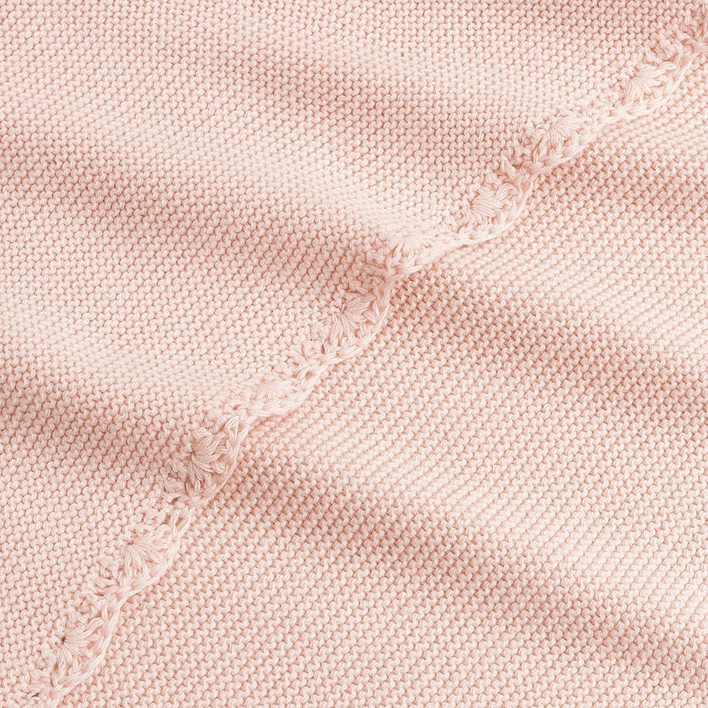 Cotton Knit Baby Blanket in Pink. Close up shot to see soft woven texture and trim detail.