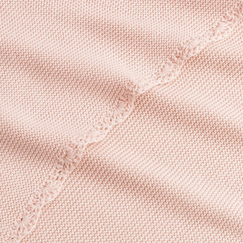 Cotton Knit Baby Blanket in Pink. Close up shot to see soft woven texture and trim detail.