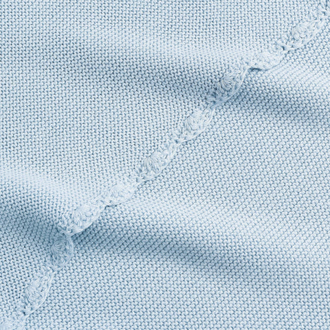 Cotton Knit Baby Blanket in Blue. Close up shot to see soft woven texture and trim detail.
