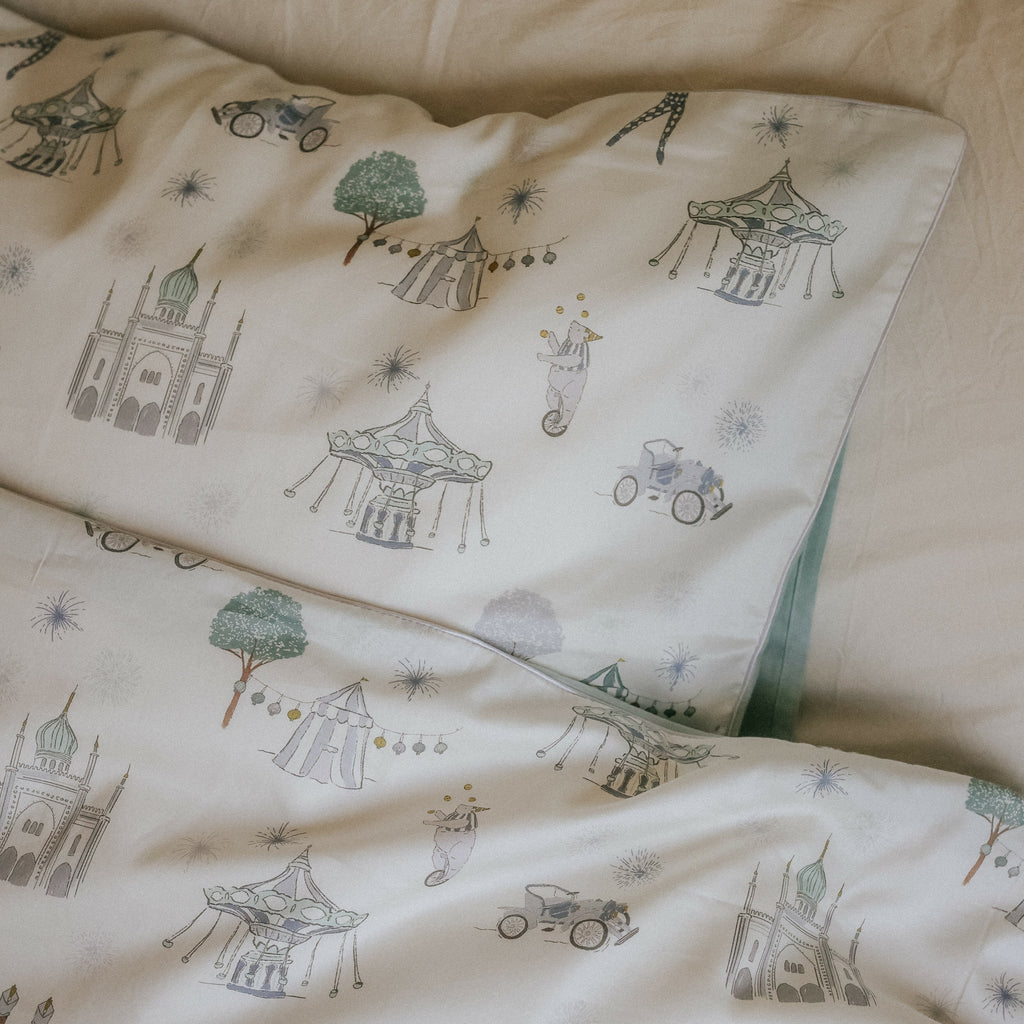 Adventures in Wonderland Full/Queen Duvet Cover in the Aqua Print displayed on bed. Shown with two standard size pillow cases in the same print.