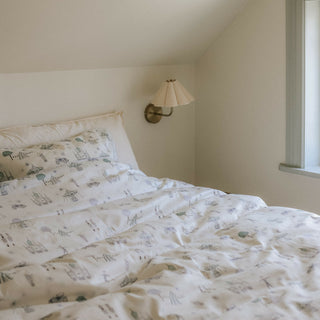 Adventures in Wonderland Full/Queen Duvet Cover in the Aqua Print displayed on bed. Shown with two standard size pillow cases in the same print.