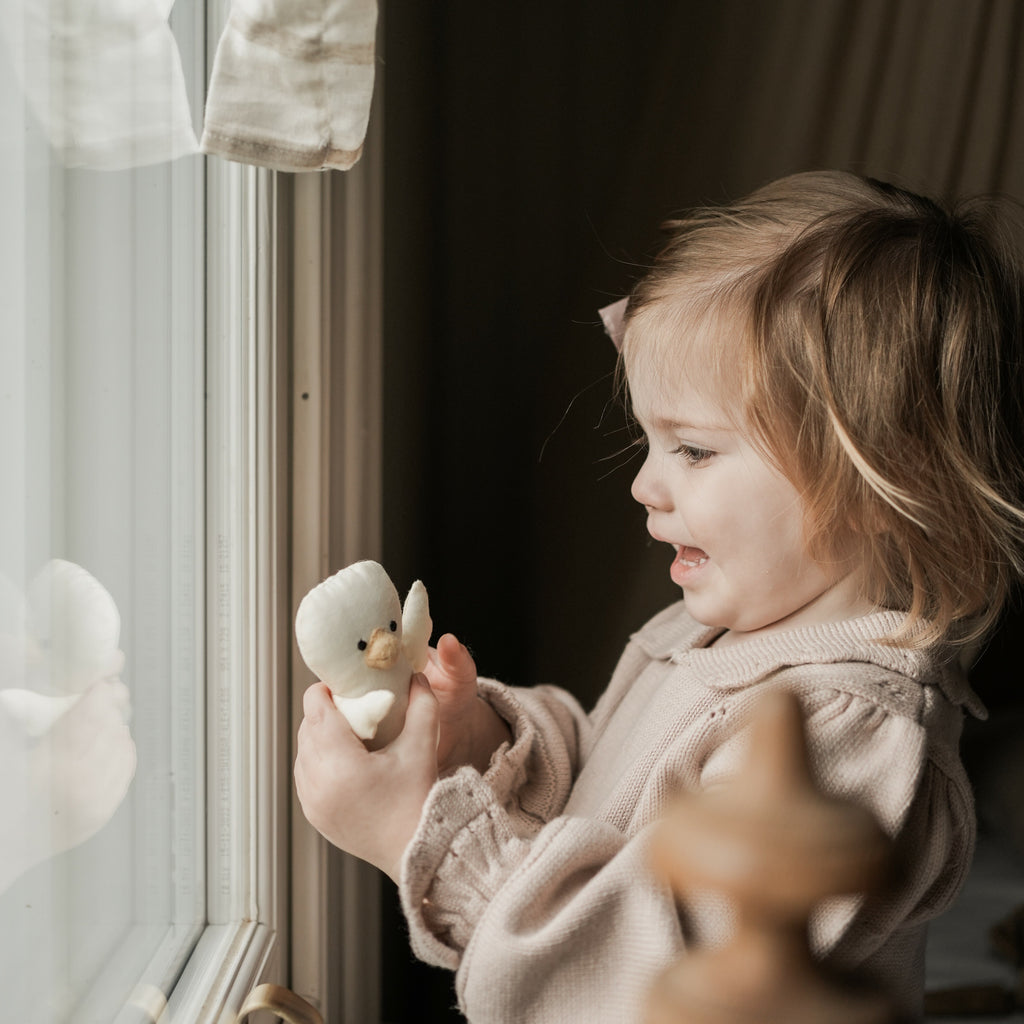 Goodnight Gooseling Activity Book. Girl playing with Gooseling