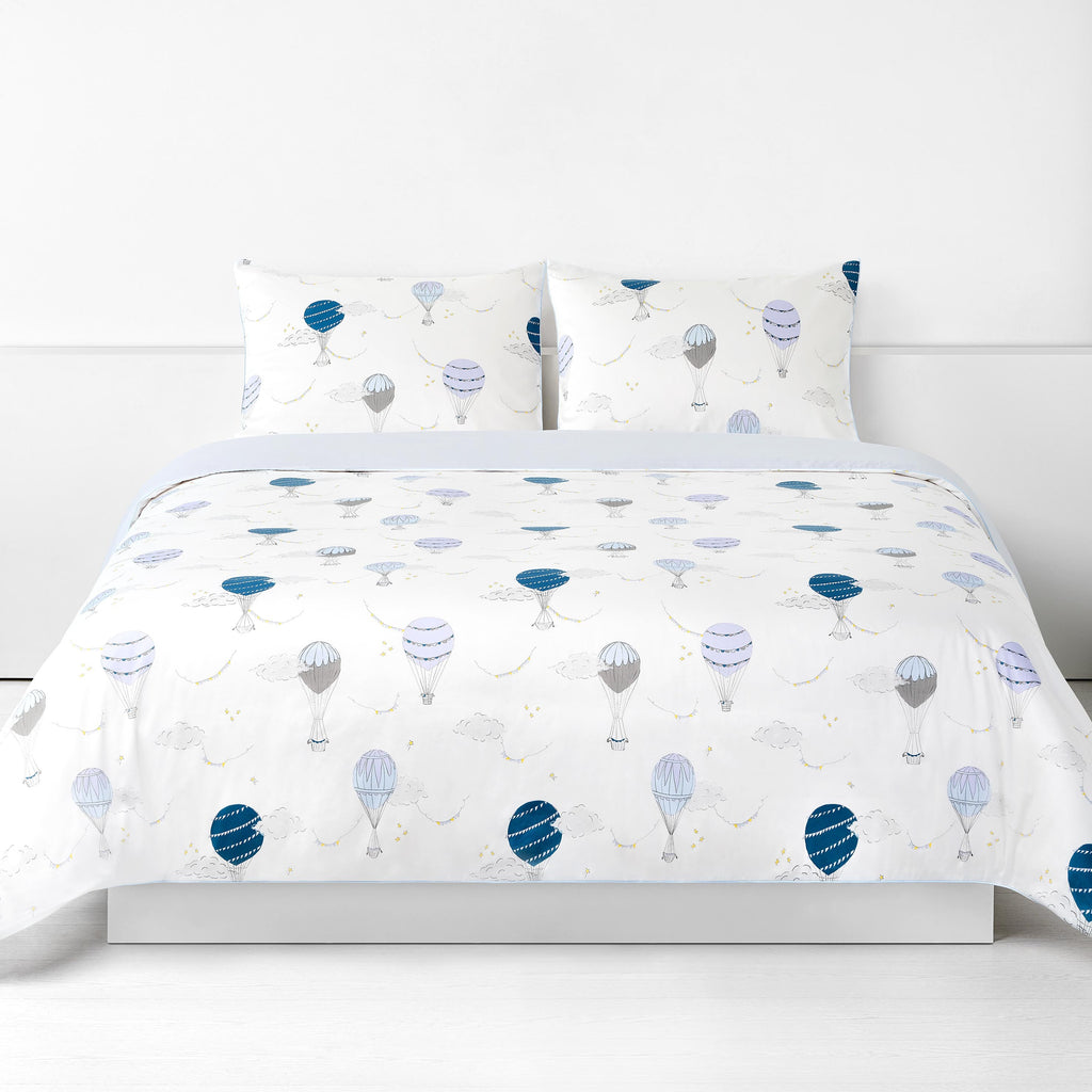 Touch The Sky Full/Queen Duvet Cover in the Blue Print displayed on bed. Shown with two standard size pillow cases in the same print.