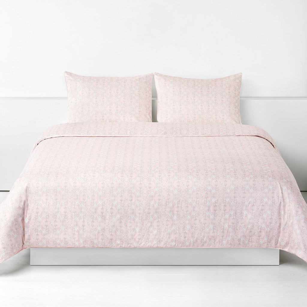 Birds Song Full/Queen Duvet Cover in the Pink Print displayed on bed. Shown with two standard size pillow cases in the same print.