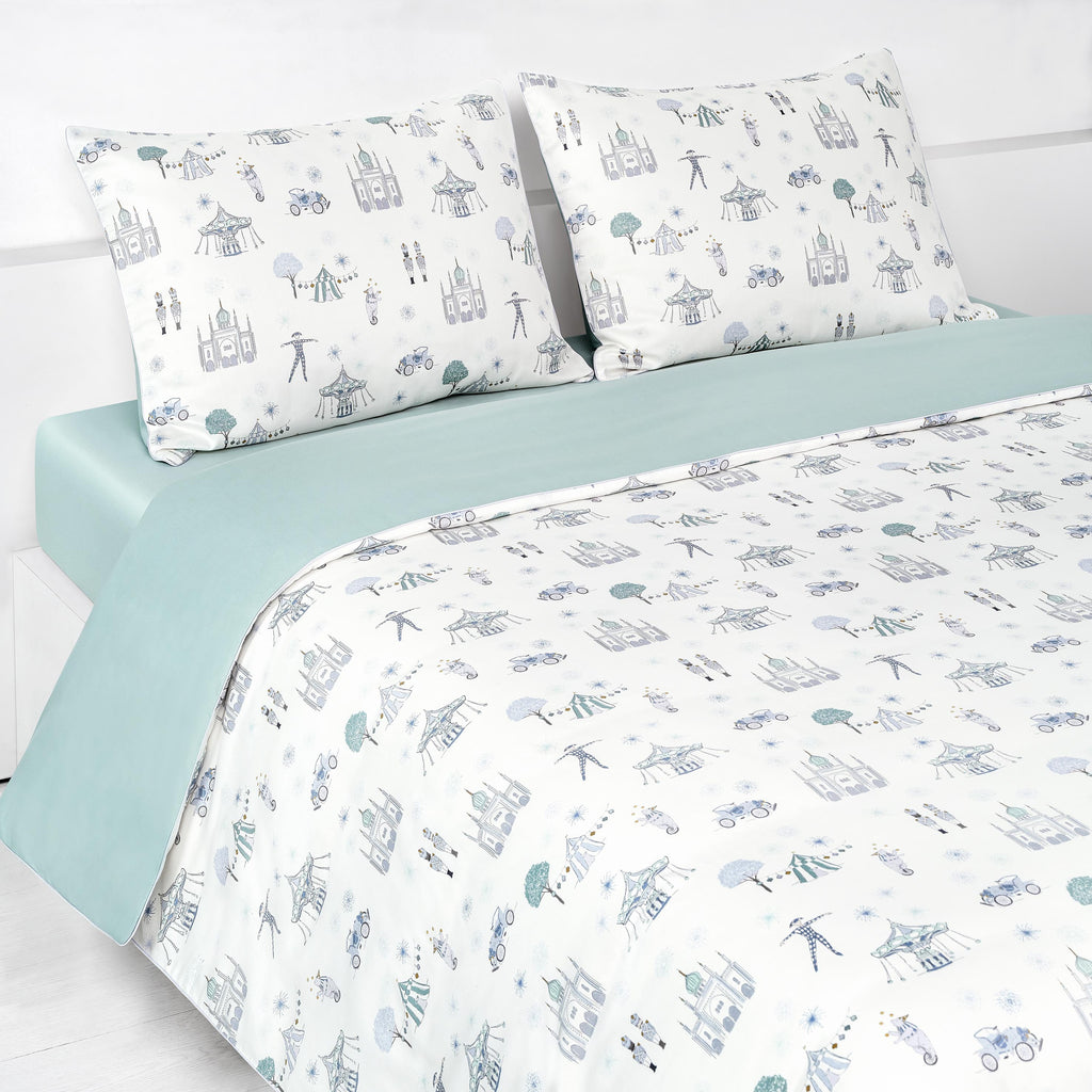 Adventures in Wonderland Full/Queen Duvet Cover in the Aqua Print displayed on bed. Shown with two standard size pillow cases in the same print.