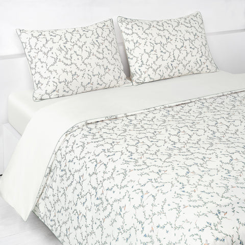 Secret Garden Full/Queen Duvet Cover in the Ivory Print displayed on bed. Shown with two standard size pillow cases in the same print.