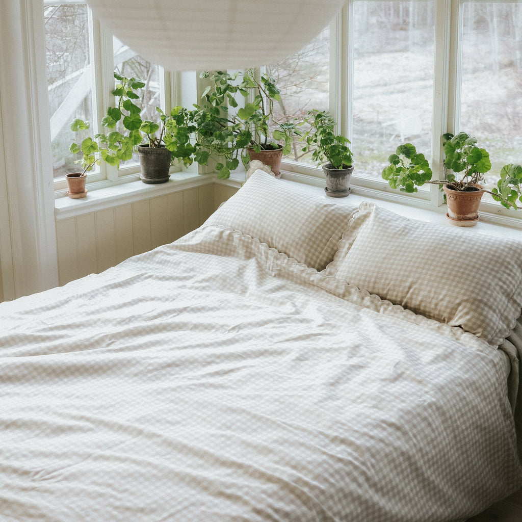 Picnic Gingham Full/Queen Duvet Cover in the Beige Print displayed on bed. Shown with two standard size pillow cases in the same print.