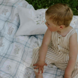 Child Sitting on Fleur & Stripe Duvet 