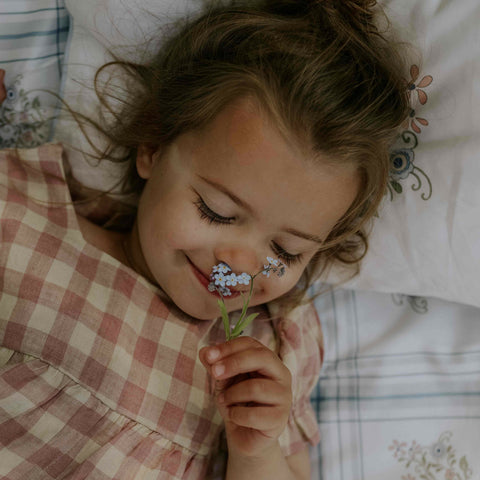 Child Smelling Flower on Duvet Cover