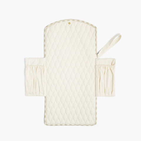 Portable Changing Pad in Beige Gingham opened up flat to see inside side pockets. Inside is Ivory quilted.