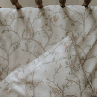 Animal Parade Toddler Pillow in Ivory. Crib Sheet, Duvet and Pillow in crib.