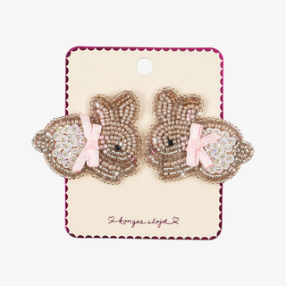 Pack of two beaded har clips in the shape of bunnies with pink ribbons. 
