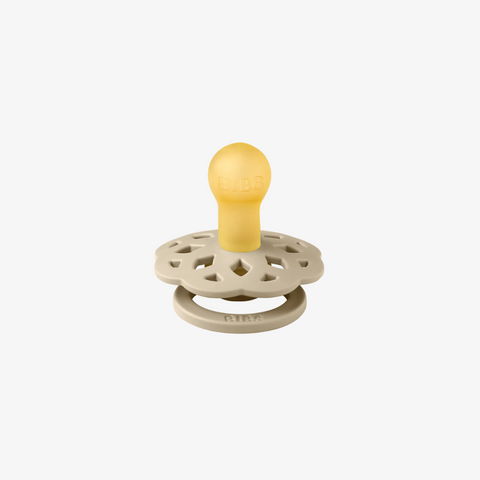 Baby teether with yellow top and beige base on a white background