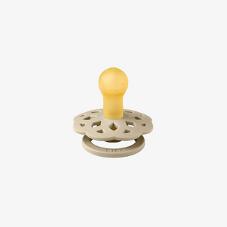 Baby teether with yellow top and beige base on a white background