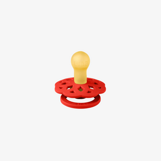 Red pacifier with a yellow center on a white background