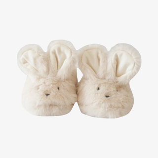 Pair of cream-colored bunny slippers on a white background