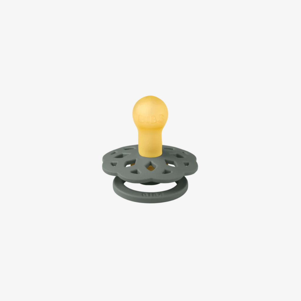green pacifier with yellow bulb on a white background