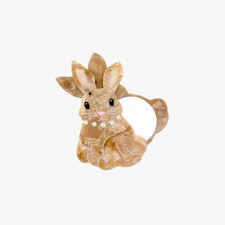 Rabbit-shaped compact mirror on a white background