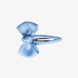 Blue ribbon bow hair clip on a white background