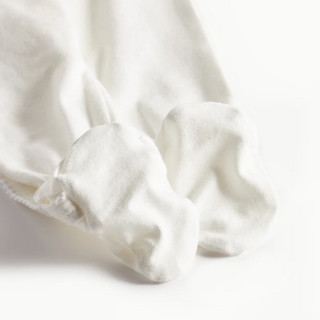 Close-up of white footies on a light background
