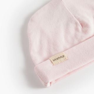 Pink baby hat with a MarMar brand label on a light gray background