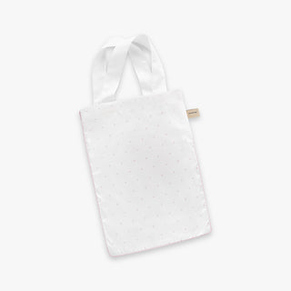 White tote bag with pink polka dots on a white background