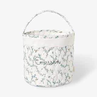 Quilted basket with Secret Garden pattern on a white background.