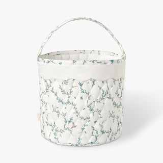 Quilted basket with Secret Garden pattern on a white background.