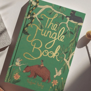 Book titled 'The Jungle Book' with illustrations on a green background
