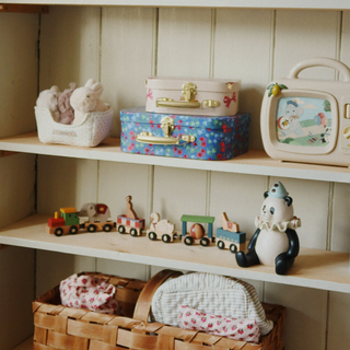 Children's toys on a wooden shelf. 