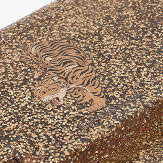 Close-up of a tiger design on a glittery surface with visible brand name "Konges Slojd"