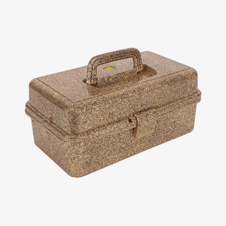 Gold glittery rectangular box with a handle on a white background