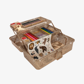 Gold glittery craft box with stationery items on a white background